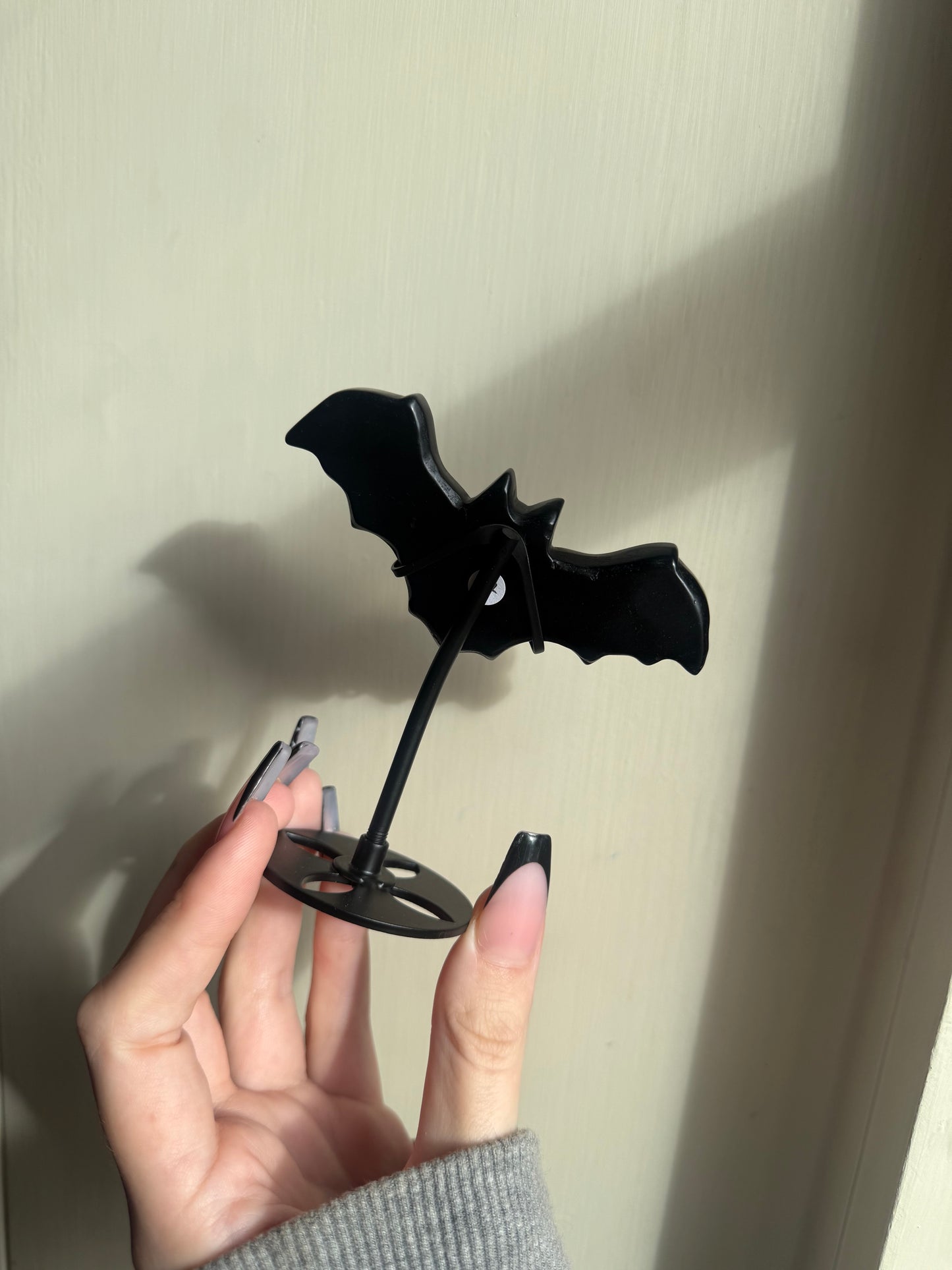 Black obsidian bat on stand