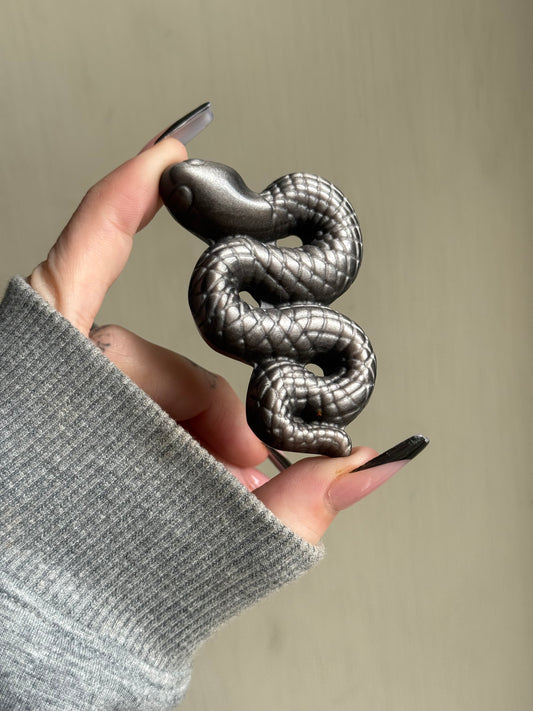 Silver sheen obsidian snake carving