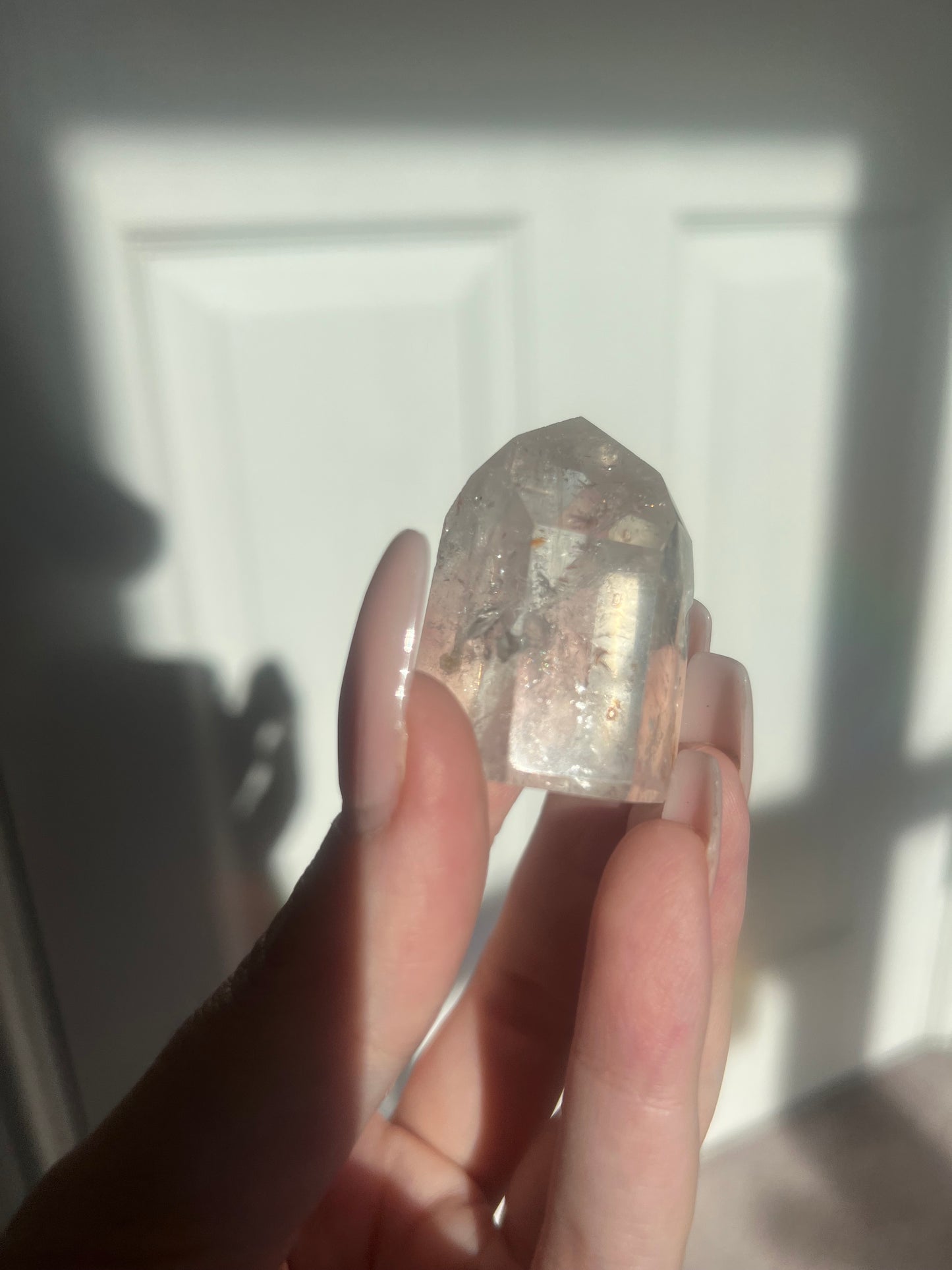 Clear quartz point with iron inclusions