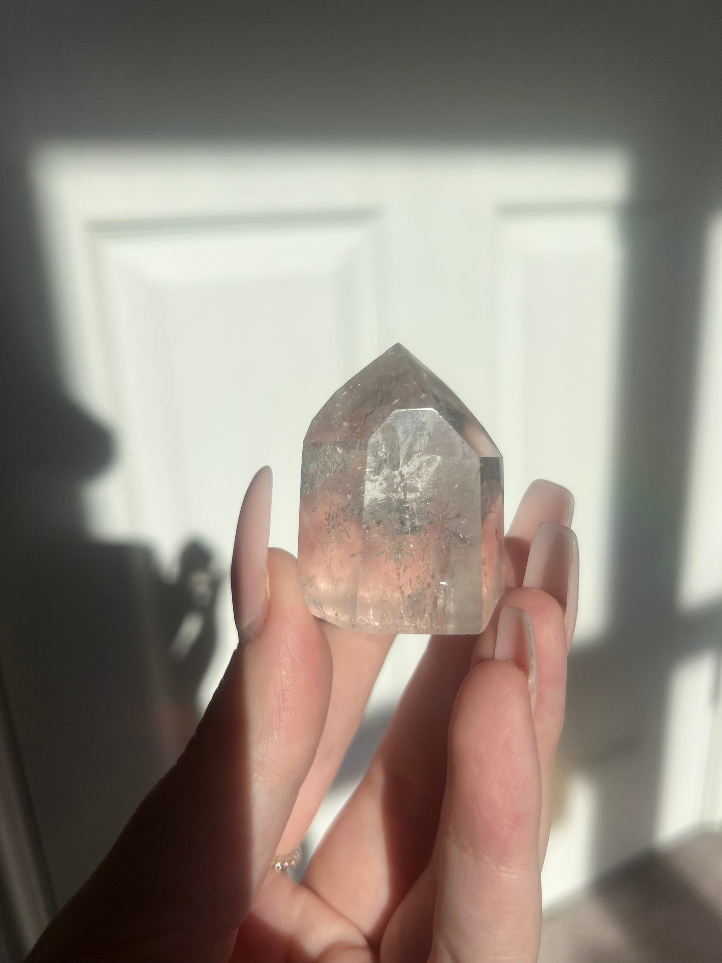 Clear quartz point with iron inclusions